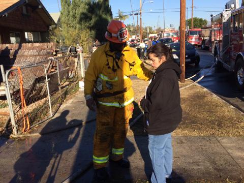 Fire Captain giving gift card to victim of house fire