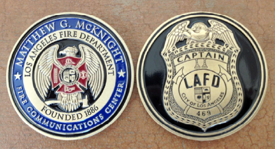  Challenge coin with the new custom logo of the Communications Center on one side with a replica of Captain McKnight's badge on the opposite side of the coin. 